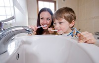 Kerry Dawson showing son Eoin (5) to turn off the tap when brushing his teeth  | NI Water News